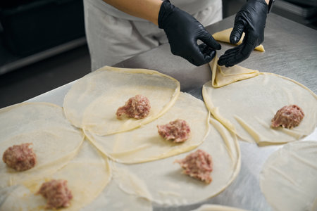 Chef shaping pancakes with minced meatの写真素材