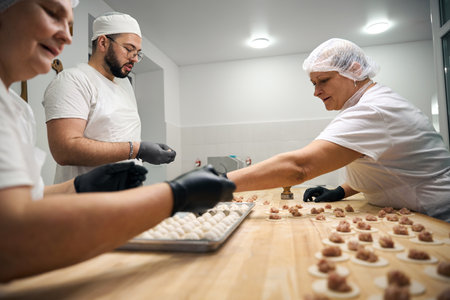Experienced kitchen staff making dumplings from minced meat and doughの写真素材