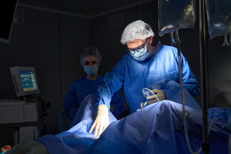 Doctors performing gynecological operation at the hospital with surgical laparoscopy equipmentの写真素材