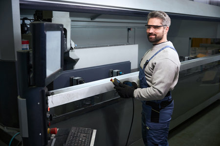 Man in work equipment at a workplace in production workshop