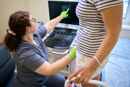 Phlebologist points to the image on a special monitor