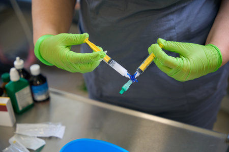 Health worker prepares a syringe with medicine for injectionの写真素材