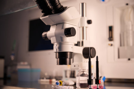 Microscope and lab equipment under vibrant colored lights