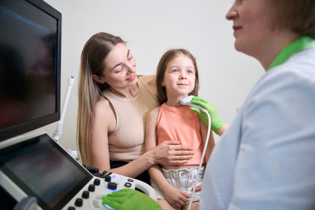 Doctor holding ultrasound probe during a medical examination