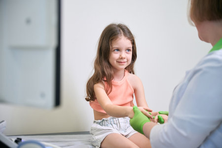 Small child sits during a medical examinationの写真素材