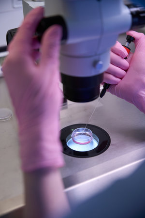 Embryologist using a microscope to examine samples