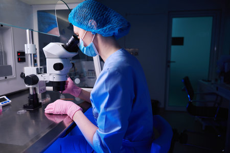 Doctor working in a dimly lit lab settingの写真素材