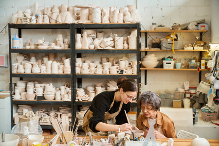 Elderly woman studies in a ceramics studioの写真素材
