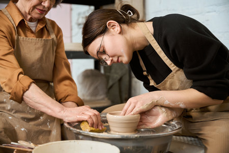 Craftswoman works on a potters wheel
