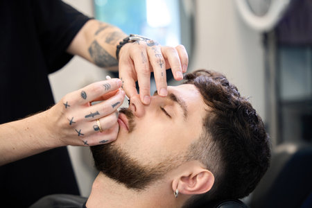 Expert groomer applies wax for hair removalの写真素材