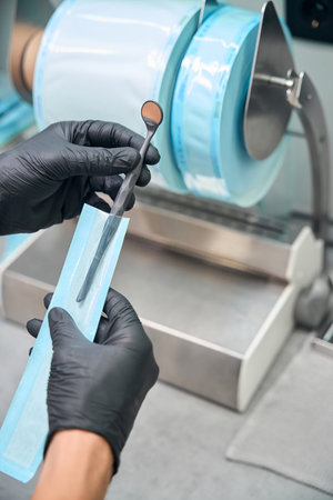 Dental assistant using heat-sealing flat reels to pack the sterile dental toolsの写真素材