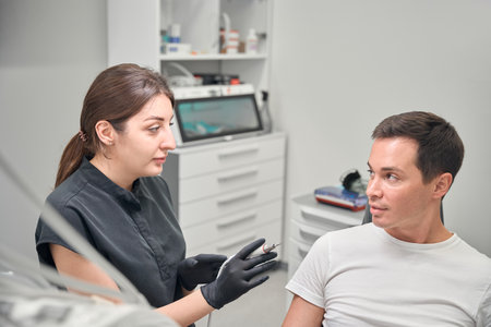 Scared male patient feeling discomfort before tooth treatment