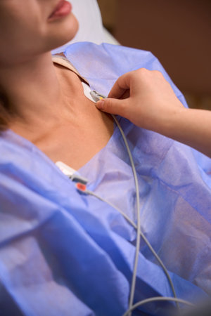 Hospital patient undergoing respiratory care while nurse assistsの写真素材
