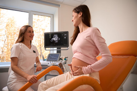 Ultrasound doctor consulting pregnant woman patient in prenatal center