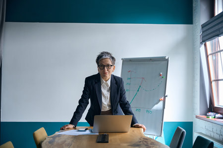 Caucasian woman working on laptop in office during daytime