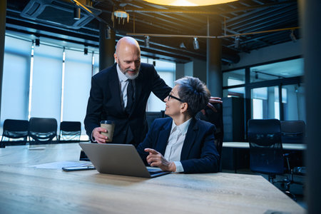 Smiling Caucasian professionals collaborating in office settingの写真素材