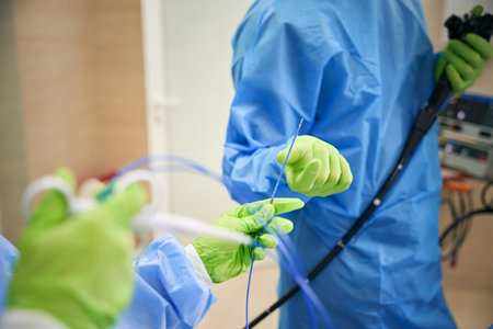 Two adults manipulating medical instruments in examination room