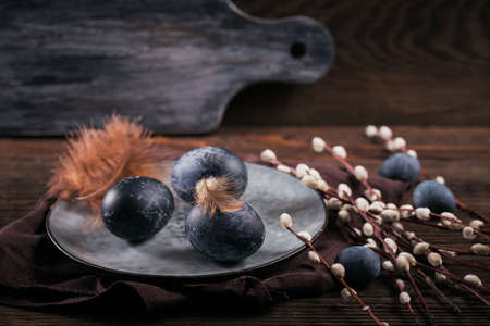 Easter eggs painted by hand in blue color with marble stone effect on dark wooden background. Chicken and quail eggs for catholic and orthodox easter holidayの写真素材