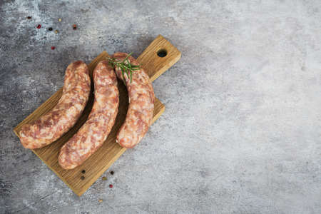Raw homemade sausages with peppercorn and rosemary herb