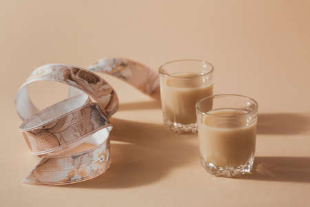 Short glasses of Irish cream Liquor or Coffee Liqueur with ribbon