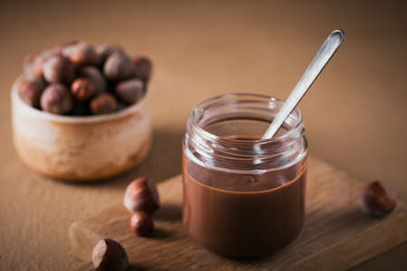 Homemade Chocolate Hazelnut Milk Spread on a brown Backgroundの写真素材