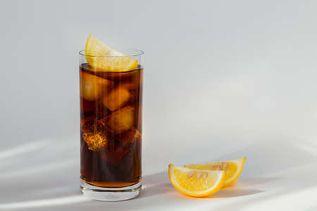 Glass of cola with ice and lemonの写真素材