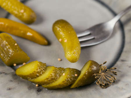Preserving pickled cucumbers, seasonings and garlic on grey plate tableの写真素材