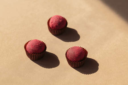 Healthy raw energy balls with cocoa on a beige background. Vegan homemade chocolate truffles Candyの写真素材