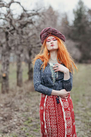Extravagant redhead woman in ethnic national dress