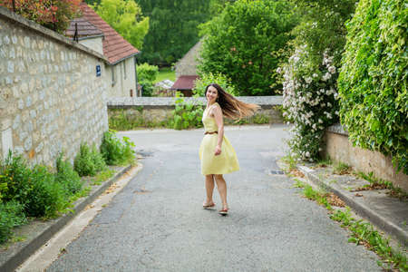 Lifestyle portrait of young stylish woman with long brunette hair