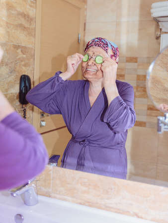 Elderly woman taking care of her faceの写真素材
