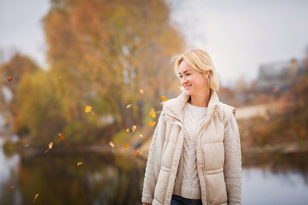 Elegante blondy woman walking and relaxing outdoors in autumn