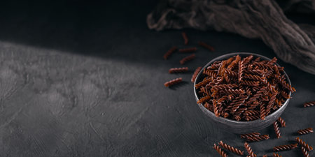 Organic uncooked Buckwheat Fusilli pasta on a dark backgroundの写真素材