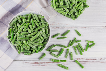 Cut green beans in a bowl and in a plastic container. Concept of homemade preparations for fast...