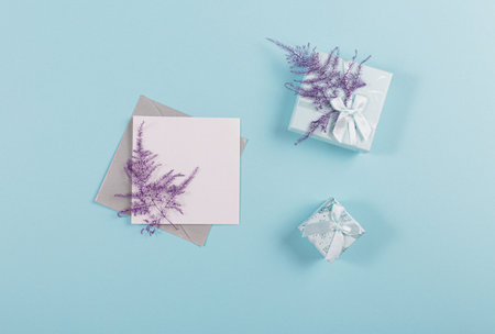 Blank greeting card mockup with envelope, blank paper, gift boxesの写真素材