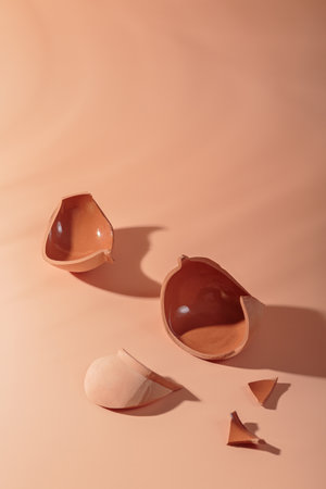 Details of broken ceramic cup on beige background
