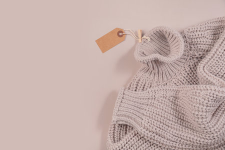Beige sweater with empty paper tag