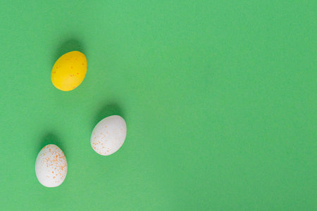 Minimalistic easter background of chocolate candy yellow and white eggsの写真素材