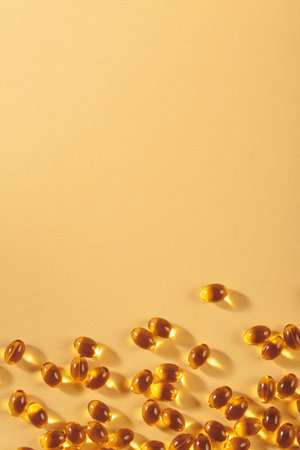 Little oil filled yellow softgels capsules of food supplements