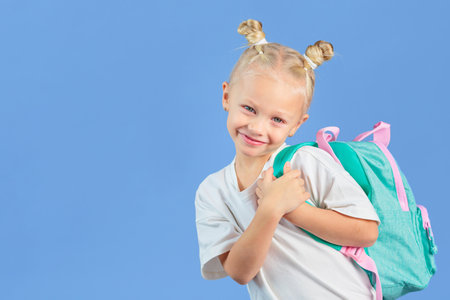 Back to school. Happy little schoolgirl with backpack
