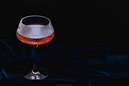 Beautiful glamorous romantic greeting card, wine glasson on dark velour fabricの写真素材