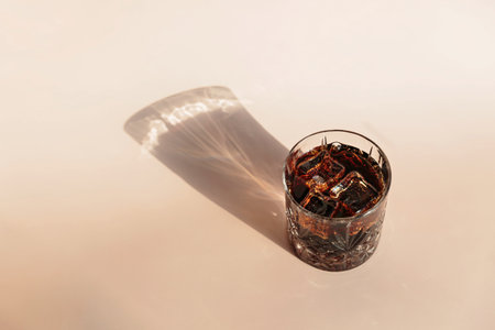 Whiskey cola cocktail with strong alcohol and ice in highball glass