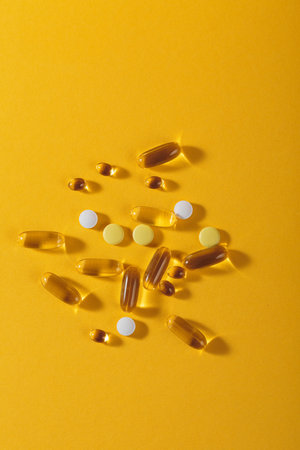 Assorted Oil filled yellow softgels capsules and pillsの写真素材
