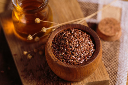Brown linen seeds, flaxseed vegetable oil on wooden backgroundの写真素材