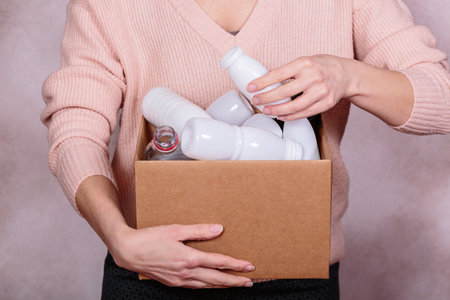 Woman Holding box of plastic garbageの写真素材