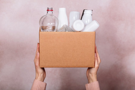 Woman Holding box of plastic garbage