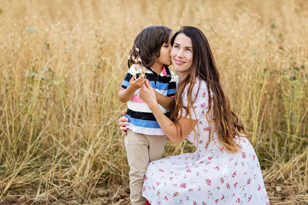 Mother and little handsome baby boy walking in the chickpeas fieldの写真素材