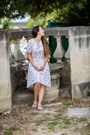 Lifestyle portrait of young stylish woman in old townの写真素材