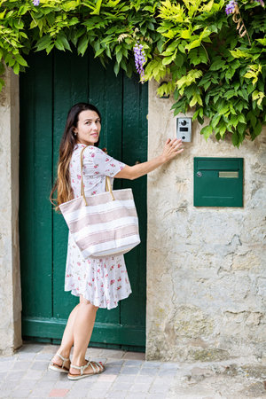 Lifestyle portrait of young stylish woman in old townの写真素材