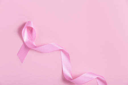 Pink breast cancer ribbon on pink backgroundの写真素材